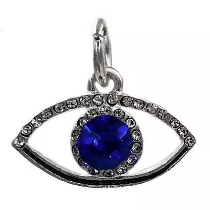 Eyes-shaped pendant with a blue gemstone on a white background